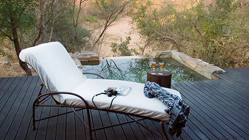 Pool and lounger outside suite at Camp Jabulani