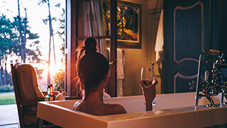 Woman relaxing in bathtub at the spa at La Residence