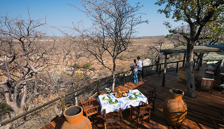 Couple looking at bush from main deck at Little Ongava Lodge