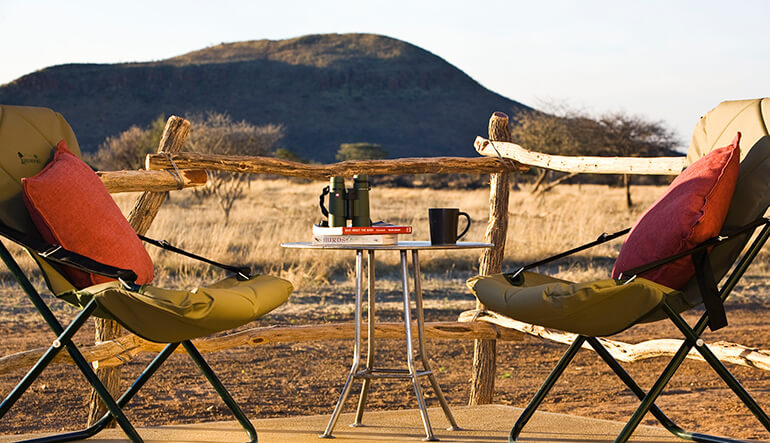 Two camping chairs looking out at the Okonjima Nature Reserve in Namibia