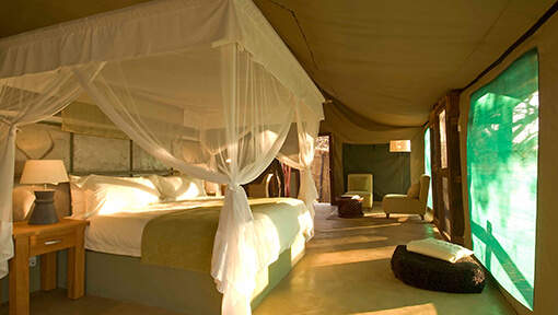 Bedroom of luxury tented safari suite at Sanctuary Puku Ridge Camp