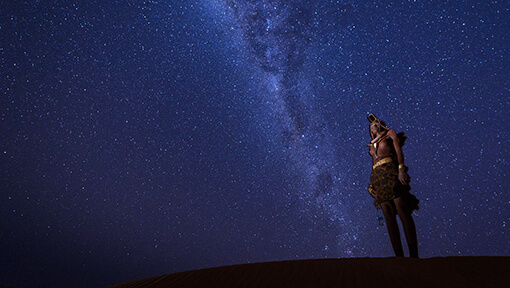 Woman from Himba Community looking at the night stars
