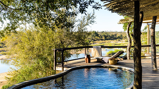 Pool with view of Sand River from deck of suite at Singita Game Reserve Boulders Lodge