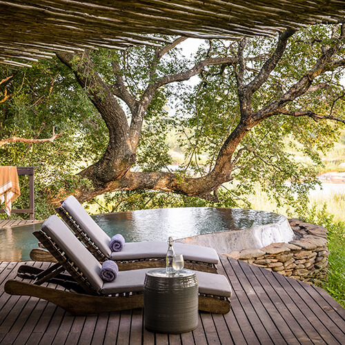 Pool and loungers on deck at Singita Game Reserve Boulders Lodge