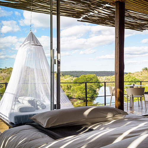 Bedroom and day bed in suite at Singita Game Reserve Lebombo Lodge