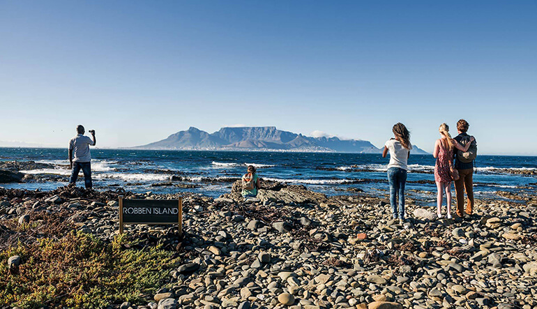 People looking at Table Mountain from Robben Island