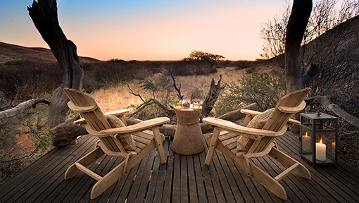 Two deck chairs overlooking the bush at Tarkuni Tswalu Kalahari
