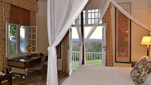Bedroom of deluxe suite at Victoria Falls Hotel 