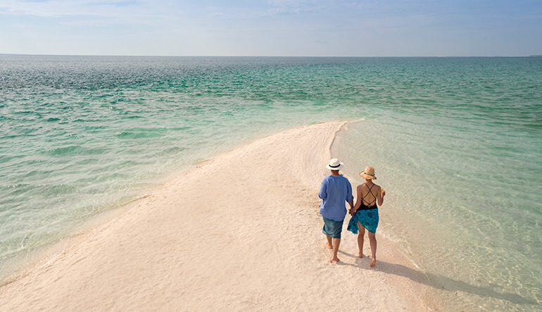 Couple walking on private island in Mozambique