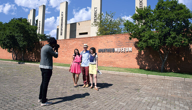 Group of people taking photographs outside the Apartheid Museum in Johannesburg