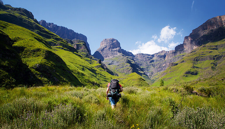 Man hiking solo in the Drakensberg Mountains