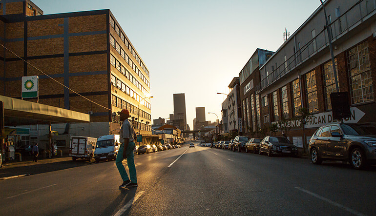 Man walking in the streets of the Maboneng Precinct in Johannesburg