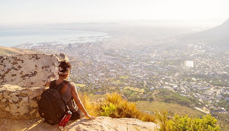 Girl looking at view of Cape Town city from the top of Lions Head