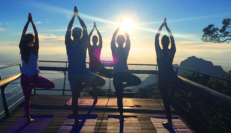 Group of people doing yoga on Table Mountain