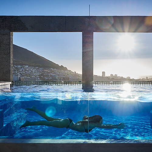 Woman in the swimming pool on the Sky Terrace at the Silo Hotel Cape Town