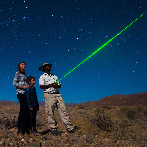 Mother, child and Little Kulala Lodge guide stargazing in Namibia