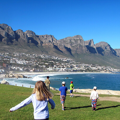 Children playing in Camps Bay by Tony Staadecker