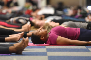 Woman in shavasana pose at the International Yoga Day 2017 in Cape Town