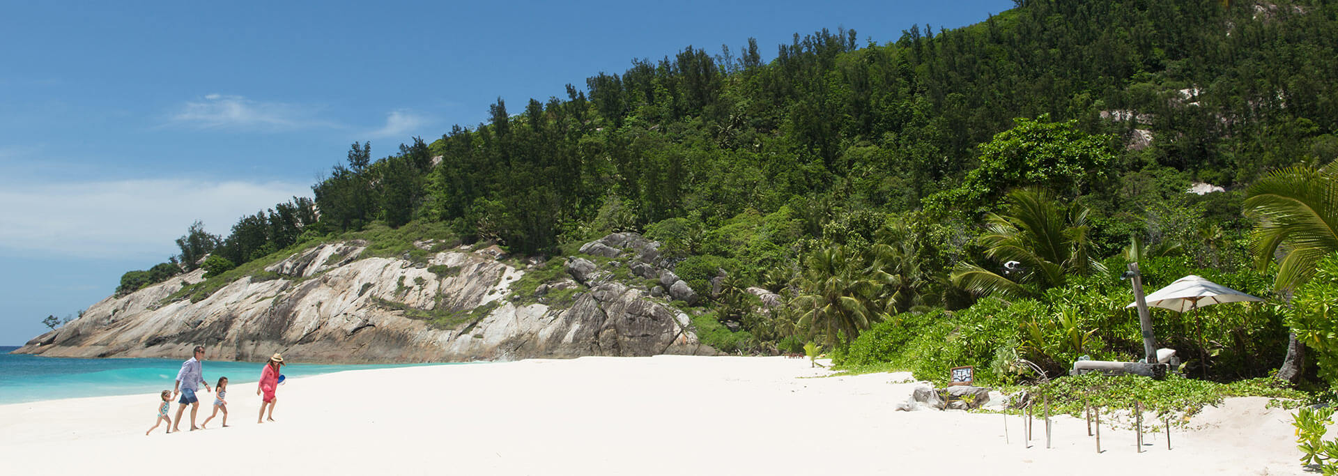 Family playing on the beach at North Island Seychelles