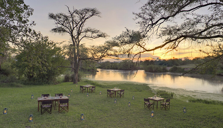 Riverside dining andBeyond Grumeti Serengeti Tented Camp in Tanzania