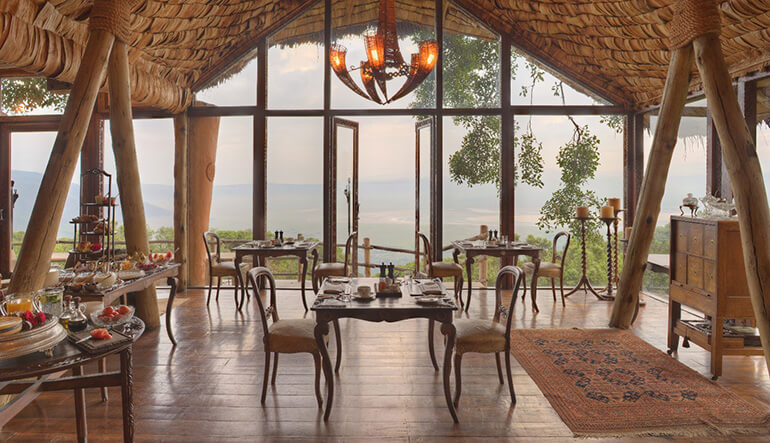 Dining at Woman relaxing at the deck of andBeyond Ngorongoro Crater Lodge