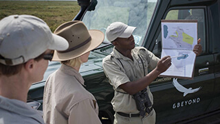 andBeyond guide with map in the Serengeti