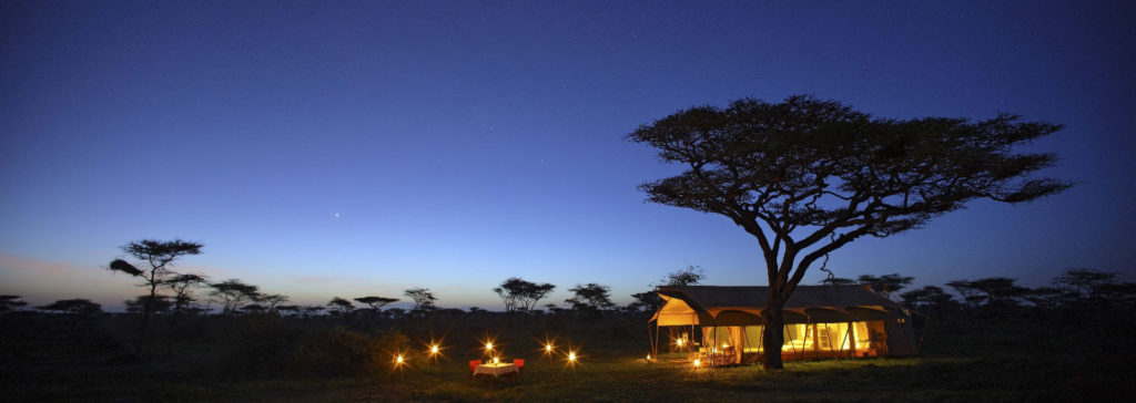 Luxury tented suite at andBeyond Serengeti Under Canvas at night