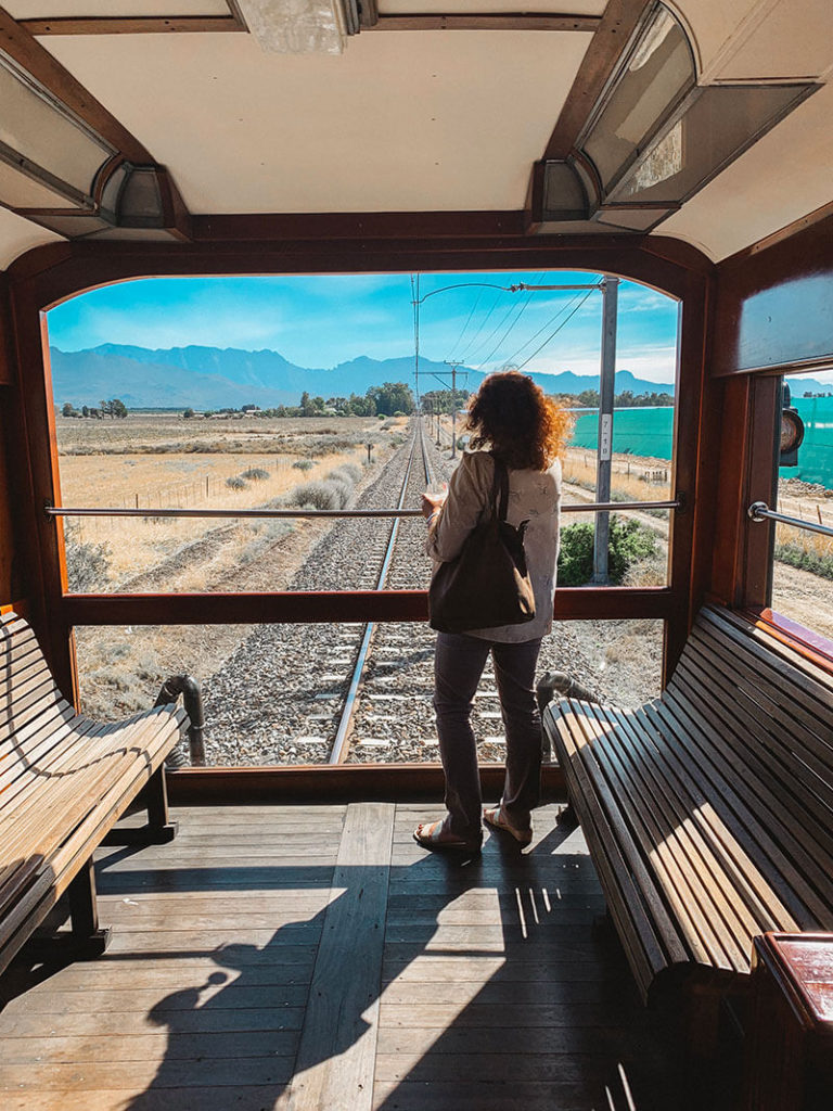 Woman drinking wine in the Rovos Rail observation cart