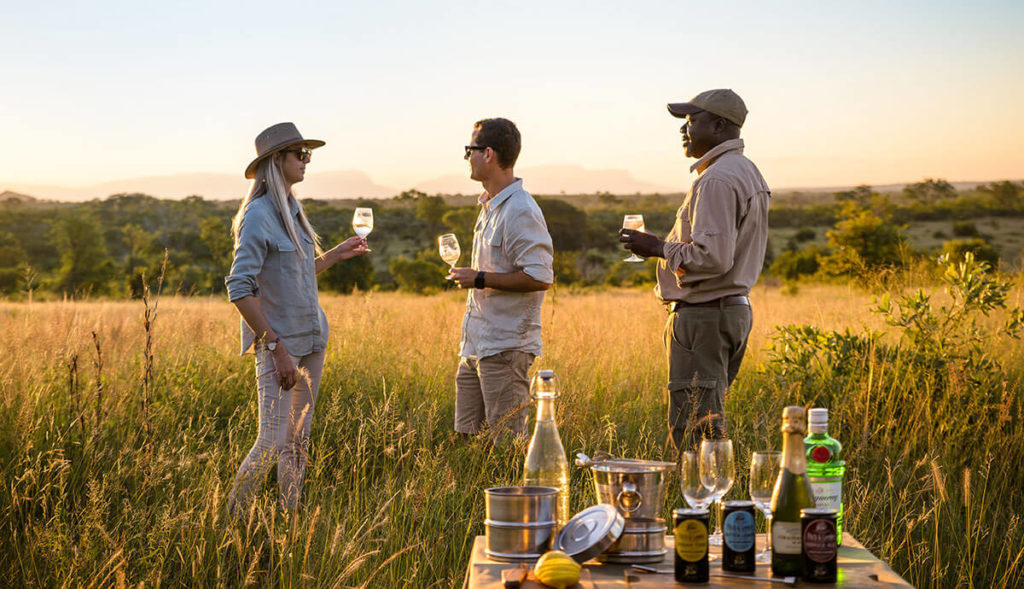 Couple enjoying sundowners in the Kruger National Park while on safari in Africa