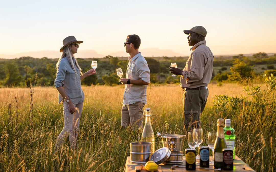 Couple enjoying sundowners in the Kruger National Park while on safari in Africa